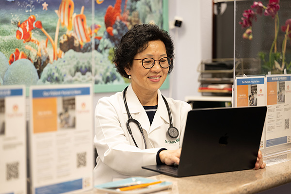Dr. Eva Chan using laptop